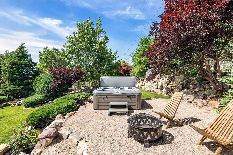Wallace Project hot tub patio with fire pit and lounge chairs