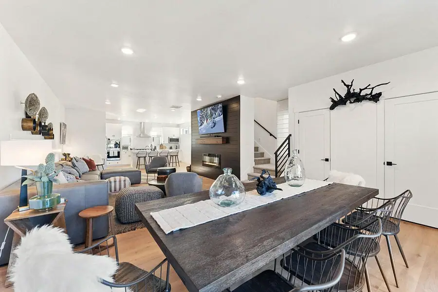 Silver Creek open living and dining with fireplace wall and kitchen beyond