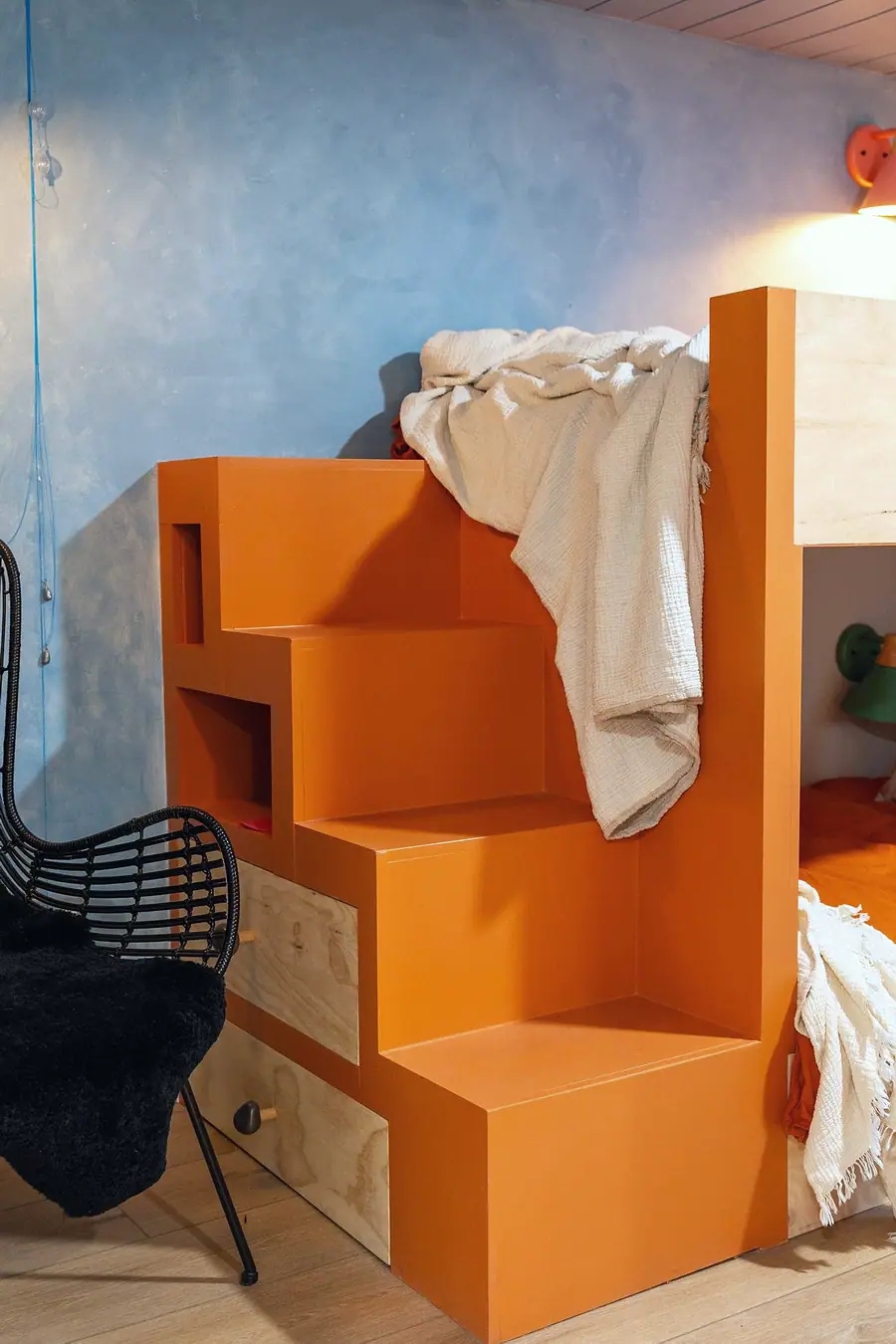 Midway orange stair storage unit with drawers climbing to the upper bunk