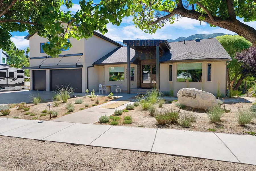 Elysium at Gracey Lane front elevation with xeriscape garden and mountain backdrop