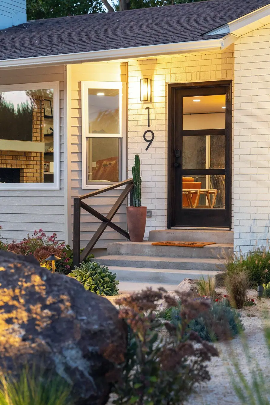Midway front door detail with house number 19, terracotta cactus, and concrete steps