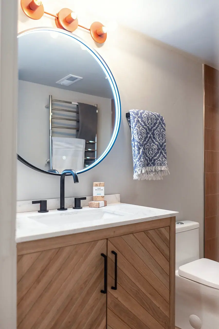 6468 S Brookstone bath vanity with lit round mirror and chevron wood doors