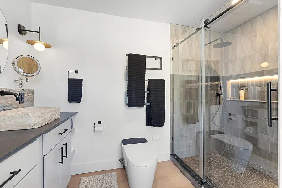 Little Gem spa bath with glass shower, heated towel rack, and smart toilet