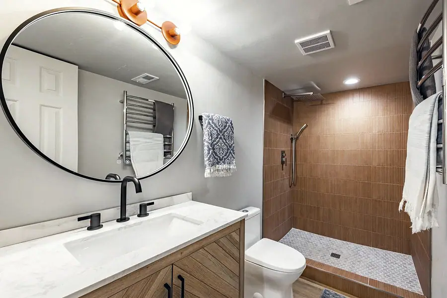 6468 S Brookstone bath with round mirror, wood vanity, and wood-tile shower