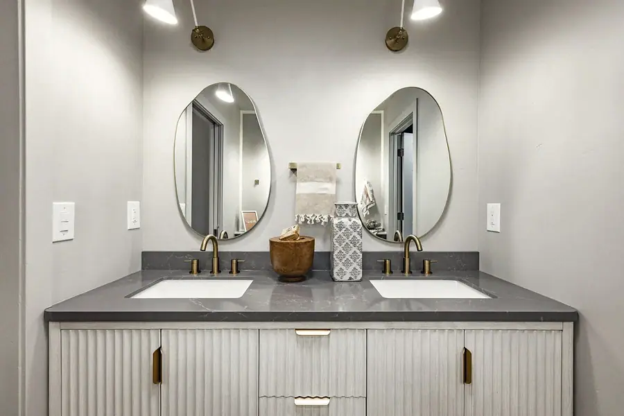 6468 S Brookstone double vanity with organic mirrors and brass fixtures