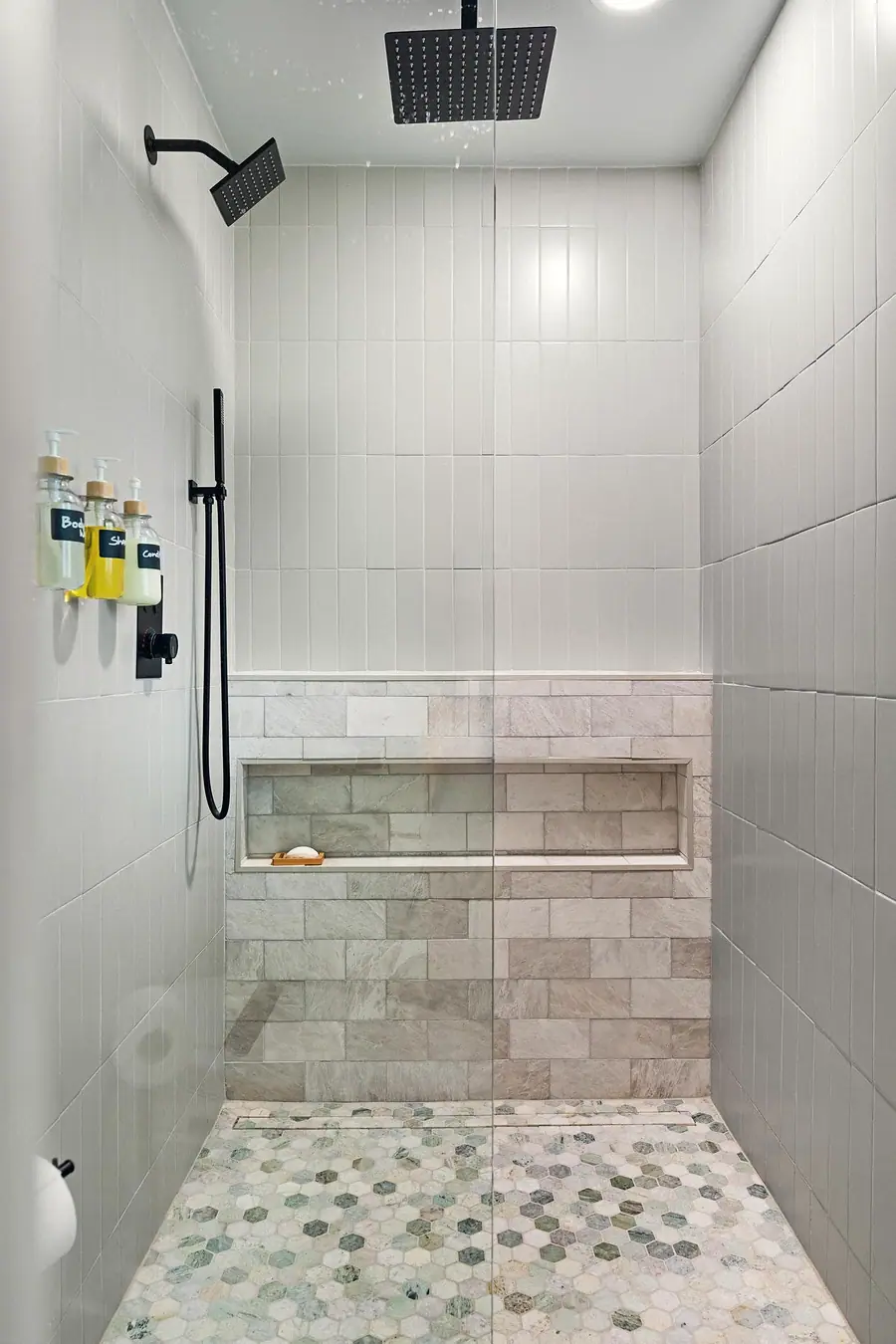 Midway walk-in shower with rain head, stone niche, and hexagonal floor tile
