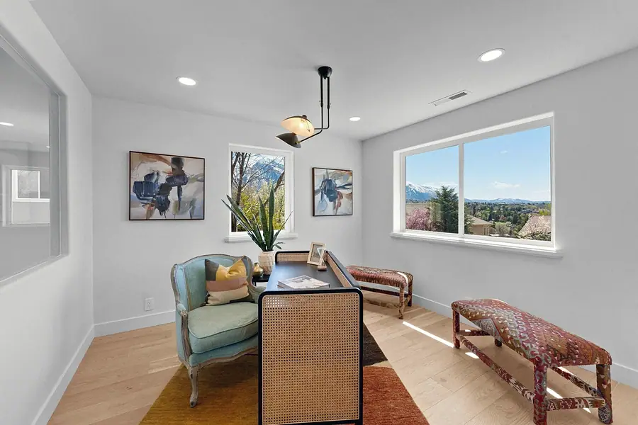 Grand Vista office with cane desk, mountain views, and patterned benches