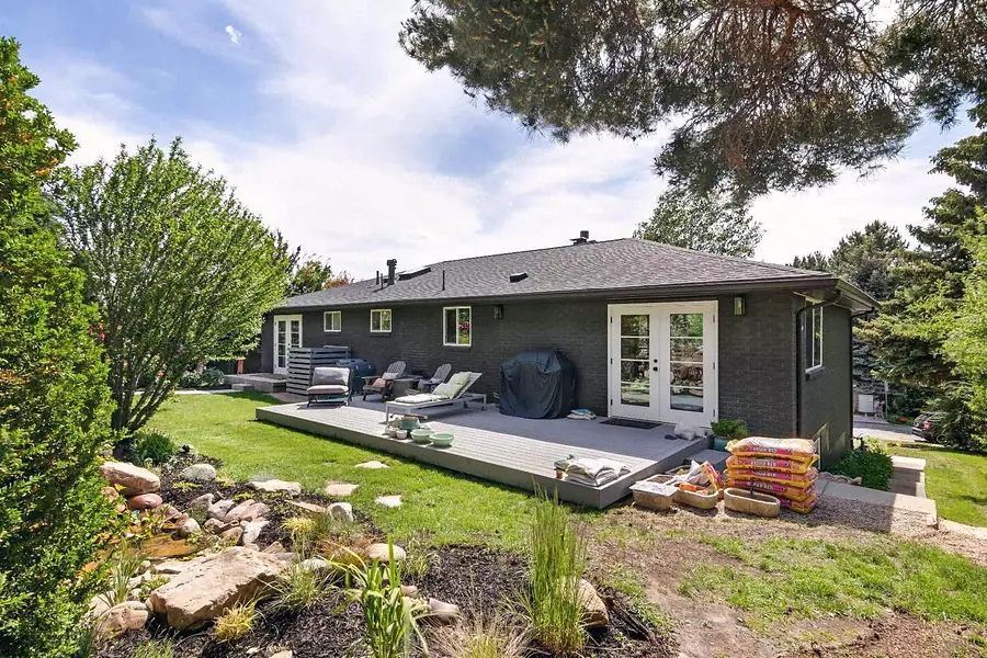 Wallace Project backyard exterior with landscaped garden and wood deck