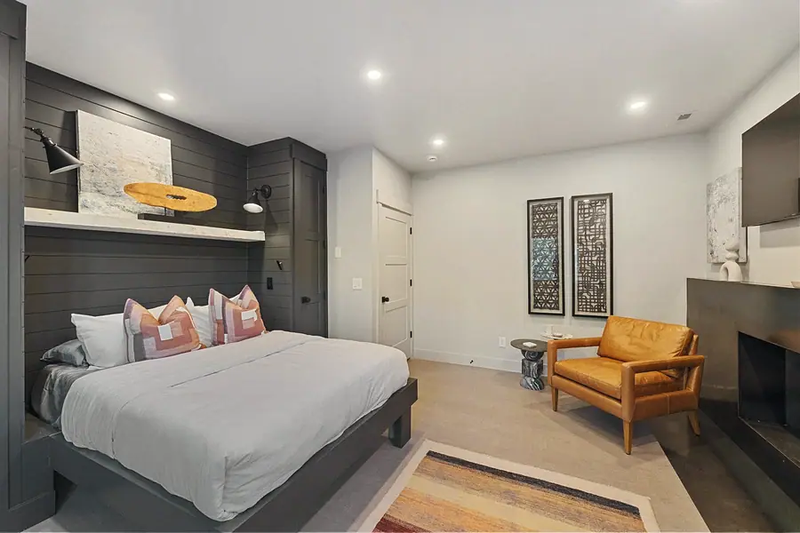 Matterhorn Hygge House primary bedroom suite with leather lounge chair and fireplace seating area