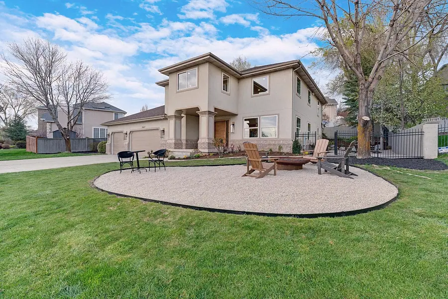 Grand Vista exterior with front lawn fire pit seating and two-story home