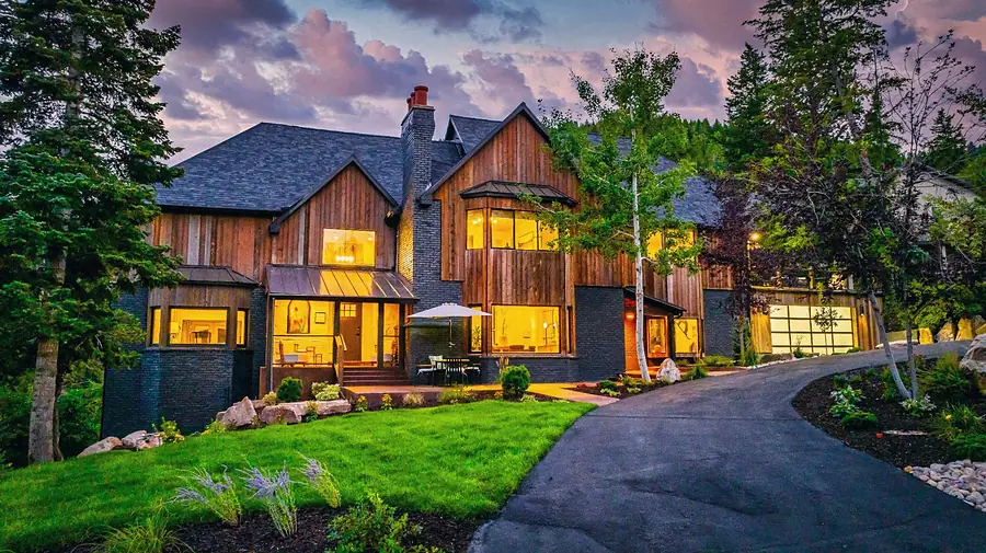 Matterhorn Hygge House entry approach at dusk with warm interior light and patio seating