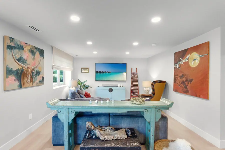 Elysium media lounge with turquoise console, blue sofa, and longhorn art
