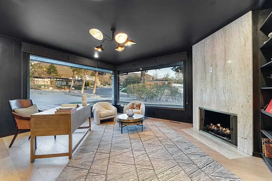 Fairway House open kitchen and living with curved black fluted column and marble island