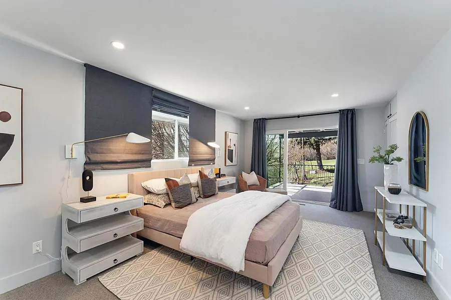 Fairway House bedroom with wood slat headboard wall and green velvet chair