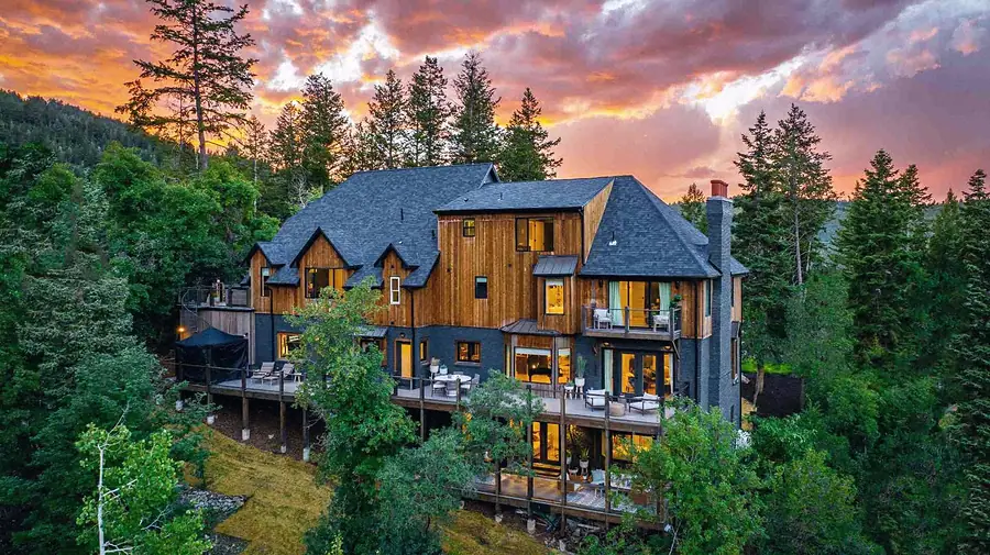 Matterhorn Hygge House aerial rear elevation at sunset with multi-level decks among the pines