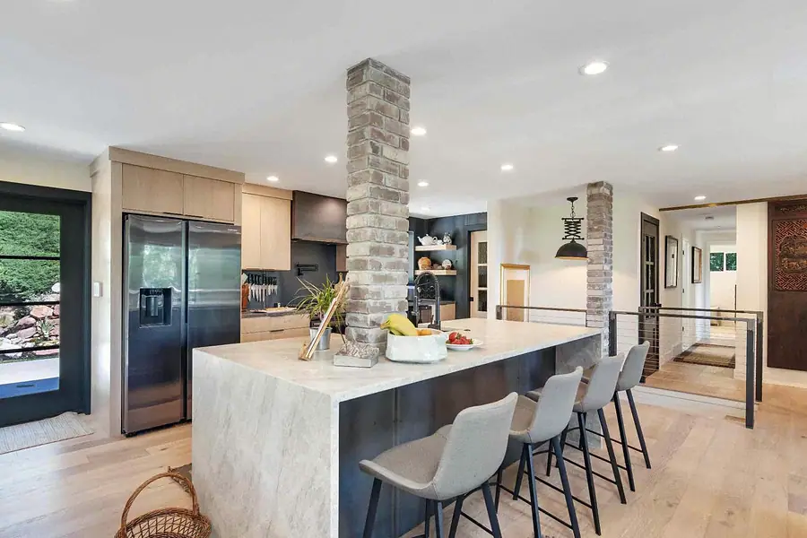 Wallace Project kitchen island with brick column and open rail beyond