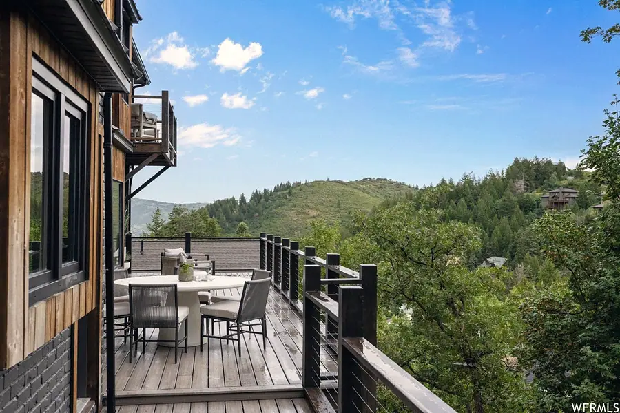 Matterhorn Hygge House outdoor dining deck with mountain and forest views