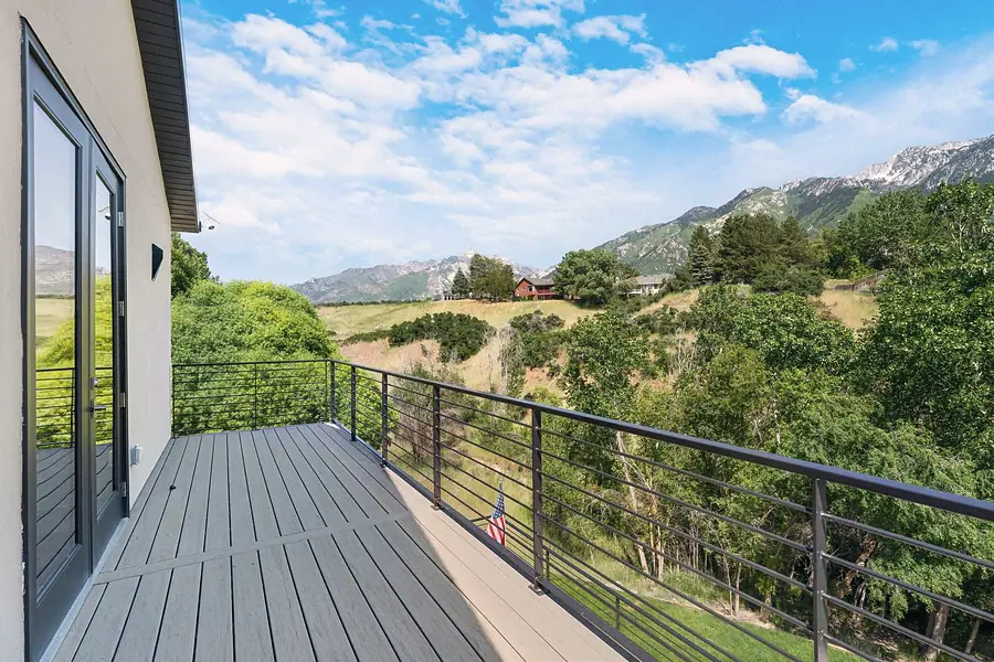Elysium upper deck with cable rail overlooking green hills and mountains
