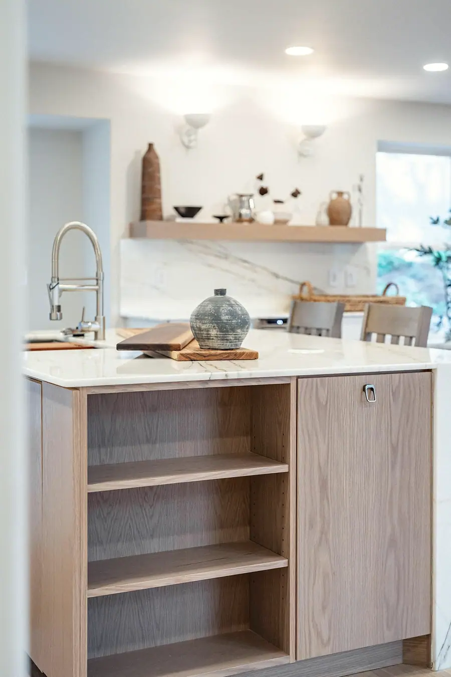 Grand Vista kitchen island with sink, wood cabinetry, and styled countertop