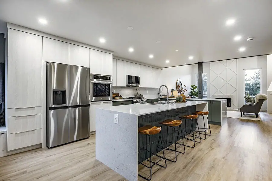 6468 S Brookstone open kitchen with island seating, stainless appliances, and living area beyond