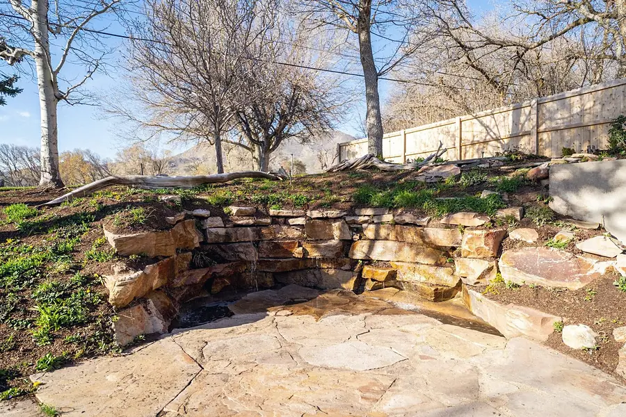 Fairway House backyard stone water feature with mountain views