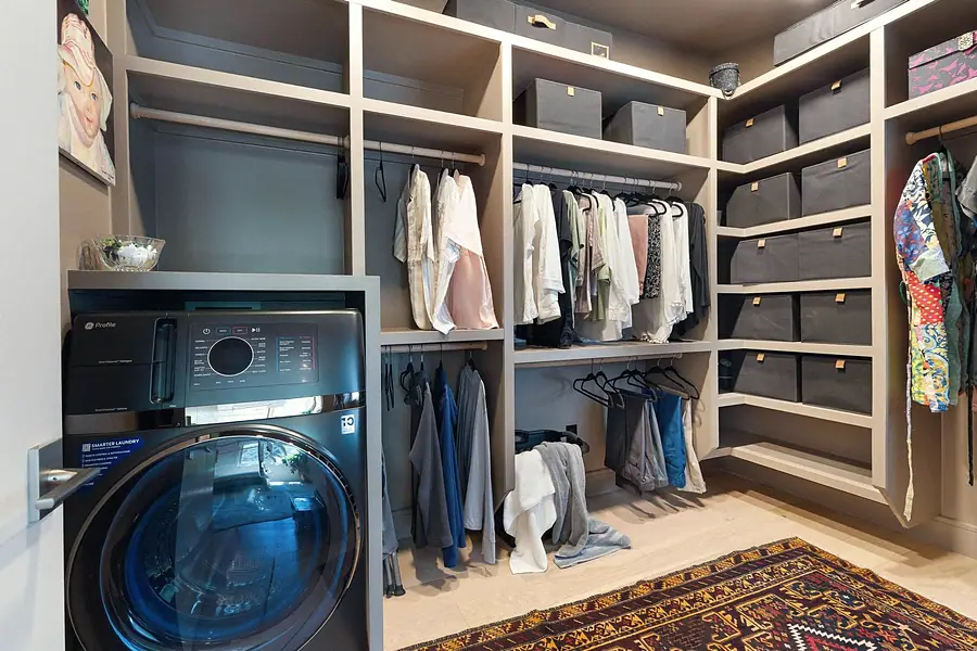 Elysium walk-in closet with built-in laundry and organized shelving