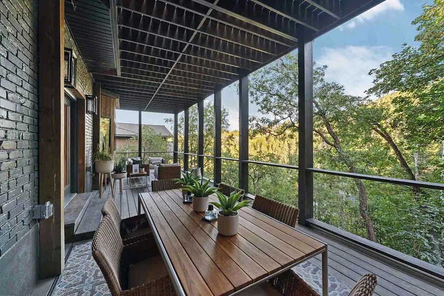 Matterhorn Hygge House covered deck dining table overlooking forested hillside