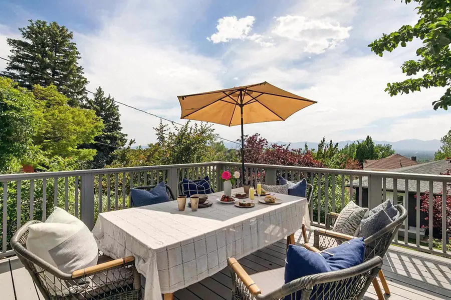 Wallace Project deck dining table with umbrella and mountain views