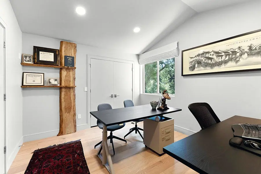 Elysium office with live-edge wood shelf, credentials, and Chinese scroll art