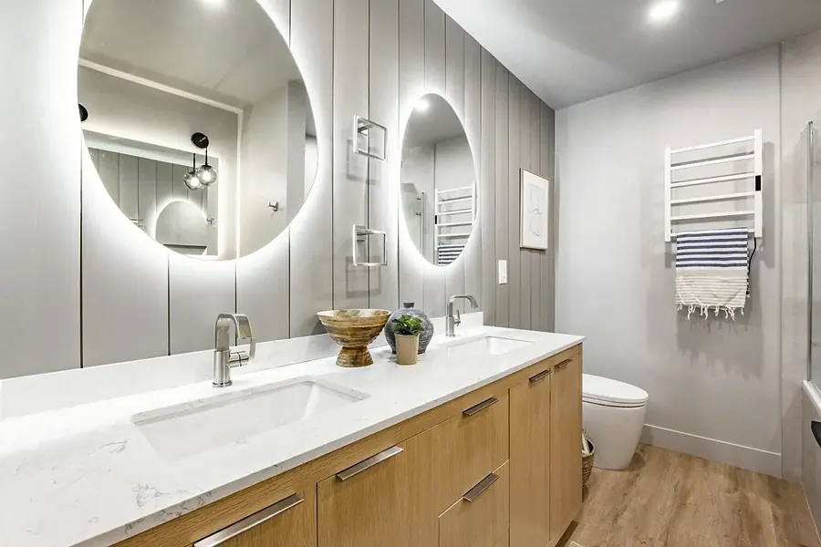 6468 S Brookstone bath with backlit round mirrors and light wood vanity